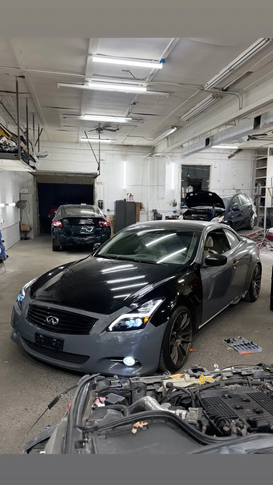 Black vehicle inside the service bay