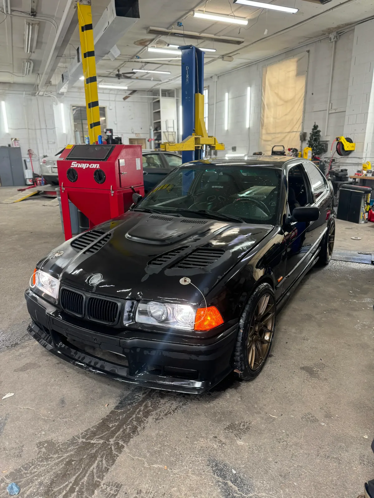 Blue BMW inside Igor’s repair facility