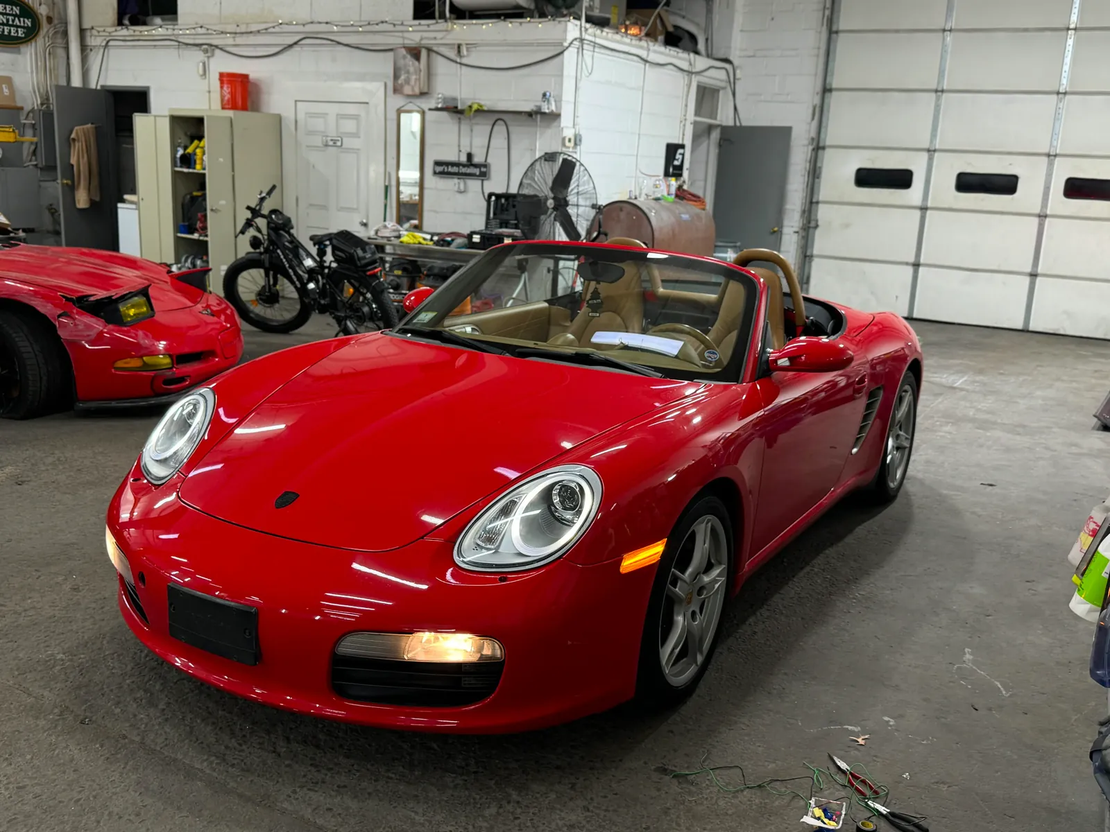 Red sports car inside Igor’s shop