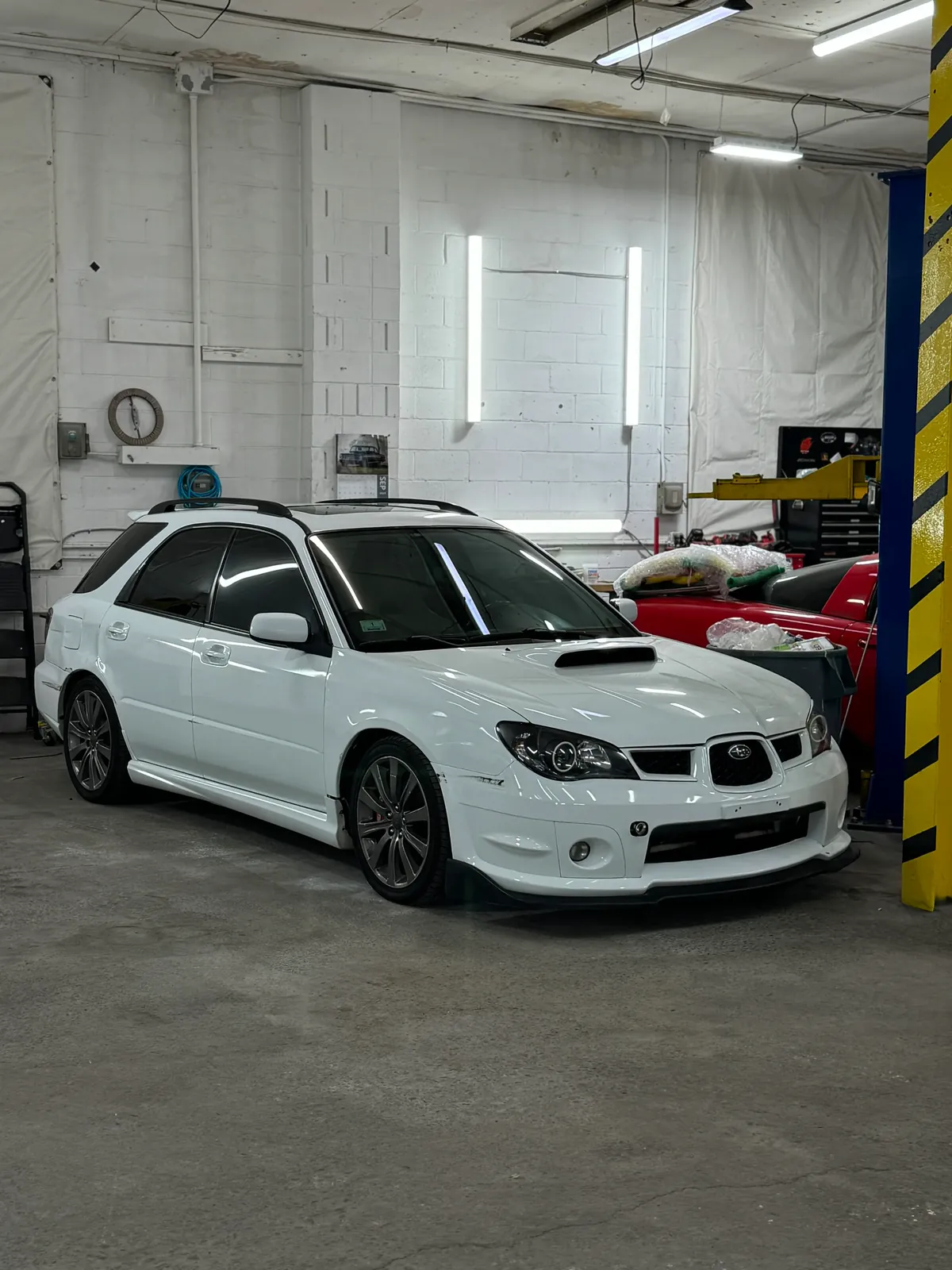 White performance vehicle inside Igor’s shop