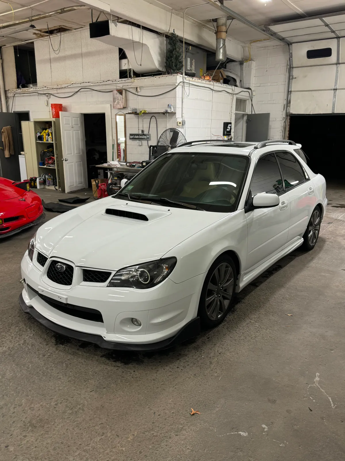 White vehicle inside Igor’s automotive shop